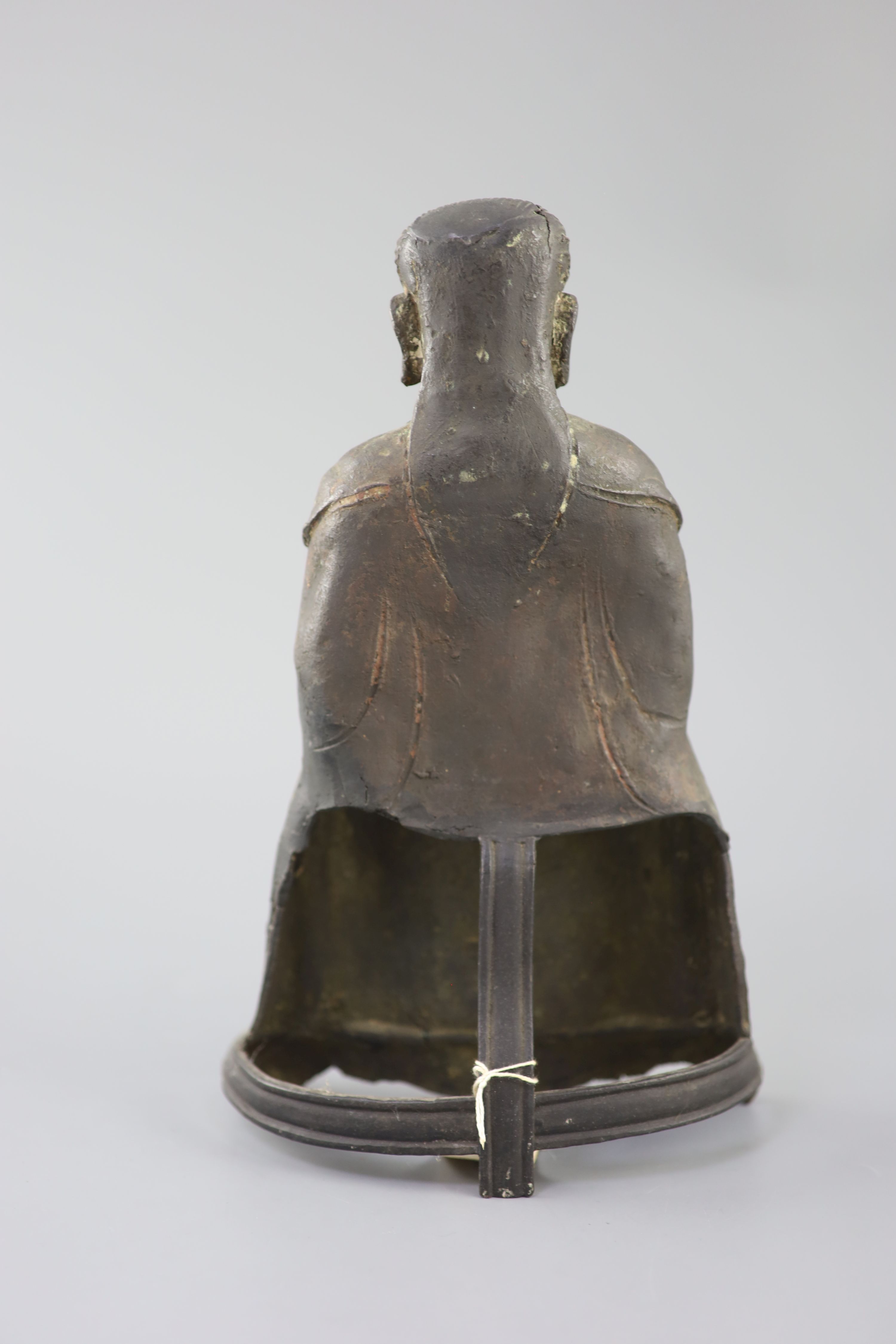 A Chinese bronze seated figure of Zhenwu, late Ming dynasty, 29cm high, casting faults, Provenance - A. T. Arber-Cooke